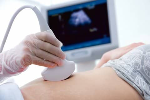Nahaufnahme eines schwangeren Bauches während einem Sonogram